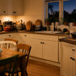 Cozy kitchen with soft lighting and wooden dining table