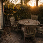 Cozy backyard with a weathered wooden dining set during golden hour