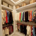 Walk-in closet with colorful clothes organized on hanging rods and leopard-print storage boxes.