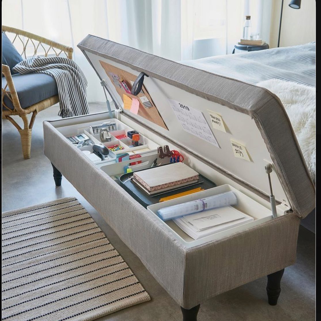 Beige fabric storage ottoman open to reveal organized office supplies and documents inside.